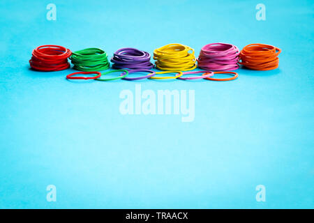 Teamwork concept. group of colorful rubber band on blue background with copy space Stock Photo