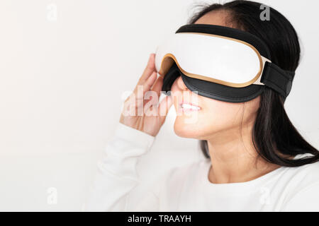 relax and massage, electric eye massage machine on women, closeup, healthcare and medicine concept Stock Photo