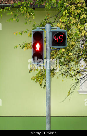 Traffic light on pedestrian crossing. Counter is counting for duration of red light. Waiting to start green light and safe crossing over pedestrian. Stock Photo