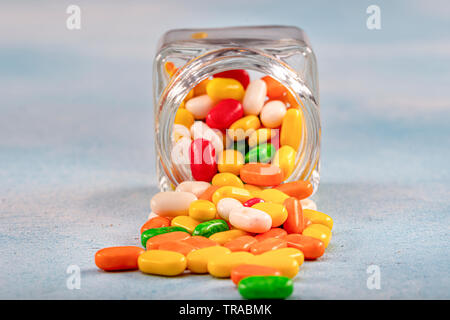 Sweet sugar candies in glass jars on brown vintage wooden background Stock Photo