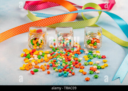 Sweet sugar candies in glass jars on brown vintage wooden background Stock Photo