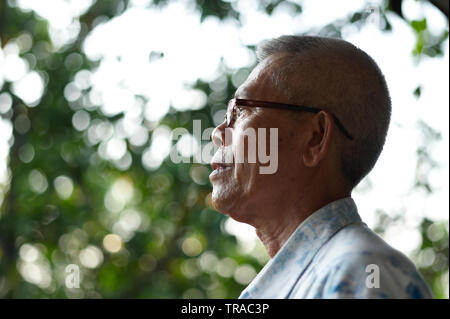 Amazing Portrait Of An Elderly Malay Man In Singapore Wearing Glasses Standing And Looking Out Into The Forest Stock Photo Alamy