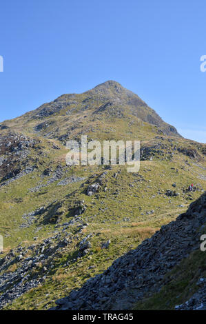 People walking on slopes of Cnicht mountain Snowdonia Stock Photo