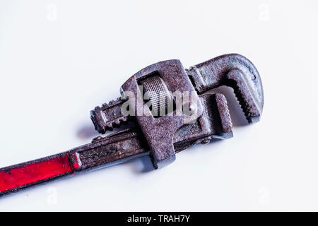 Closeup of rusted pipe wrench hand tool in isolated background Stock Photo
