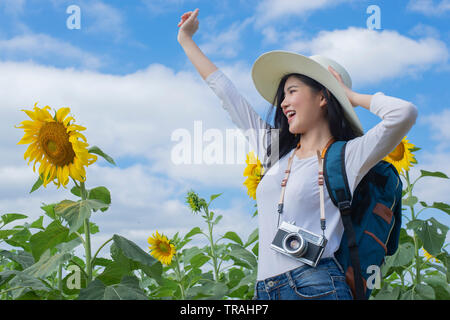 Asian young woman visit sunflower field - Image Stock Photo