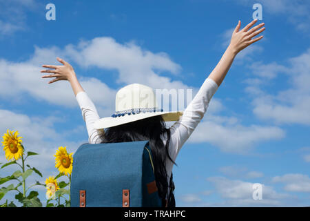 Asian women visit sunflower fields on vacation - Image Stock Photo