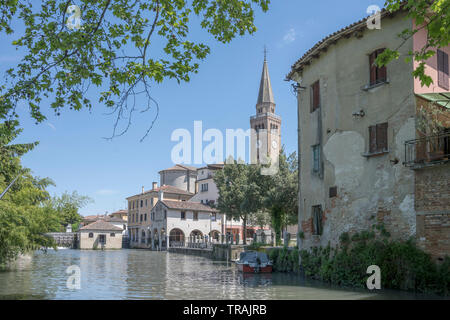cirtyscape with Lemene river and old historical buildings in square nearby, shot at Mediterranean little town of Portogruaro, Venezia, Veneto, Italy Stock Photo