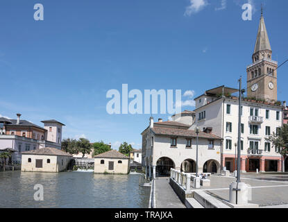 cirtyscape with Lemene river, ancient water mill and old historical buildings in square nearby, shot at Mediterranean little town of Portogruaro, Vene Stock Photo