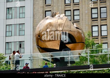 People viewing The Sphere, 25-foot (7.6 m) high, cast bronze sculpture by German artist Fritz Koenig, Liberty Park, World Trade Center, New York, NY. Stock Photo