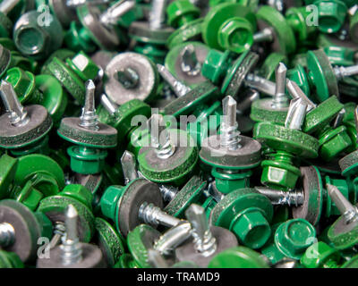 Background from roofing screws of green color Stock Photo