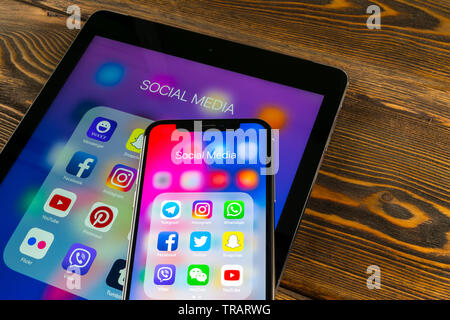 Sankt-Petersburg, Russia, May 30 2018: Apple iPad and iPhone X with icons of social media facebook, instagram, twitter, snapchat application on screen Stock Photo