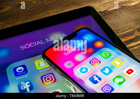 Sankt-Petersburg, Russia, May 30 2018: Apple iPad and iPhone X with icons of social media facebook, instagram, twitter, snapchat application on screen Stock Photo