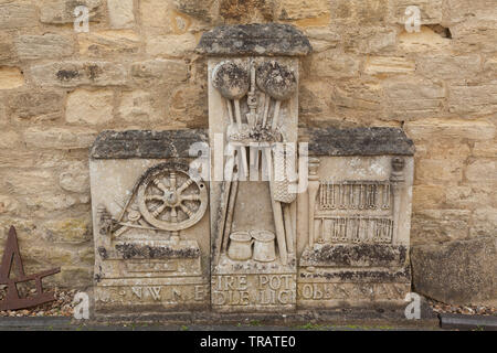 Stone carved images of spinning, weaving, lace making Stock Photo