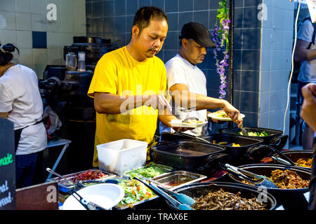 27th May 2019 Free From Festival, two men preparing dishes at a street food stall, London, UK Stock Photo