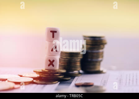 Tax concept and stacked coins on invoice bill paper for time tax filling paid debt payment at office business finances Stock Photo