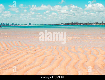 sand ridges and ripples on beach with blue water in Paraiba, Brazil - Areia vermelha Stock Photo