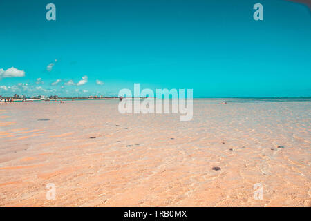 sand ridges and ripples on beach with blue water in Paraiba, Brazil - Areia vermelha Stock Photo