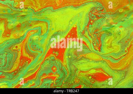 photography of abstract marbleized effect background. green and orange creative colors Stock Photo