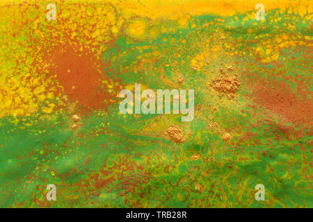 photography of abstract marbleized effect background. green and orange creative colors Stock Photo