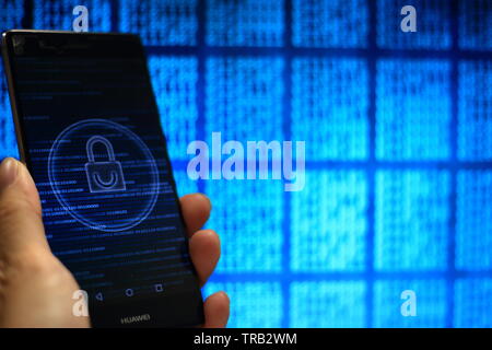 secured private data in big data era. computer code and padlock icon in a hand. mobile phone and computer display. Stock Photo
