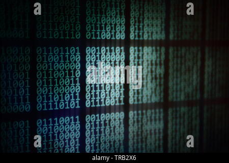 looming data. overhead plane led panel displaying pale blue green binary code data on black background. digital information and internet cloud drive c Stock Photo