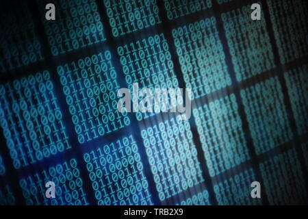looming data. overhead plane led panel displaying pale blue green binary code data on black background. digital information and internet cloud drive c Stock Photo