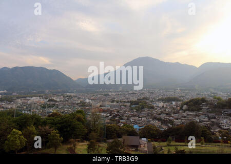 The landscape of Beppu in Oita and golf range as seen from a hill in sunset. Including the steam! Stock Photo