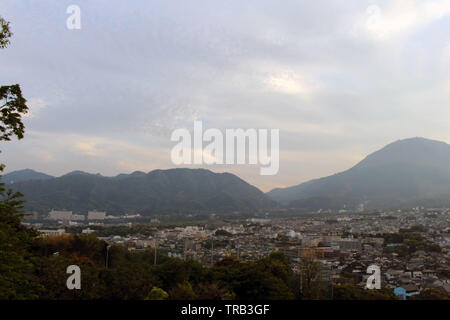 The landscape of Beppu in Oita and golf range as seen from a hill in sunset. Including the steam! Stock Photo