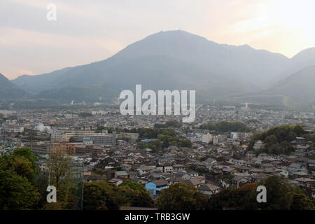 The landscape of Beppu in Oita and golf range as seen from a hill in sunset. Including the steam! Stock Photo