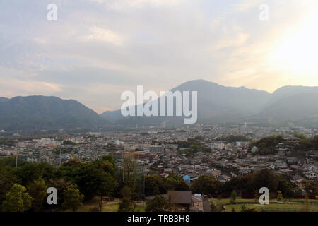 The landscape of Beppu in Oita and golf range as seen from a hill in sunset. Including the steam! Stock Photo