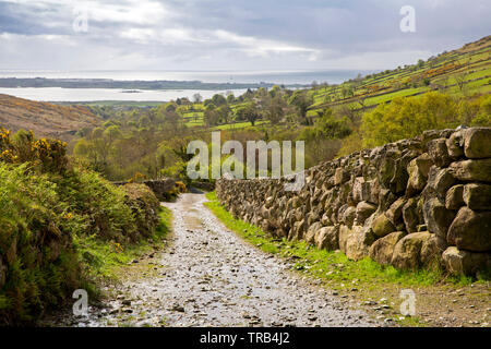 Northern Ireland, Co Down, Low Mournes, Curraghknockadoo, rocky lane at Trooper’s Hollow overlooking Carlingford Lough Stock Photo