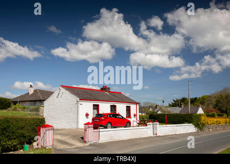 Ireland, Co Louth, Cooley Peninsula, Rooskey, red car parked in small cottage with red painted windows Stock Photo