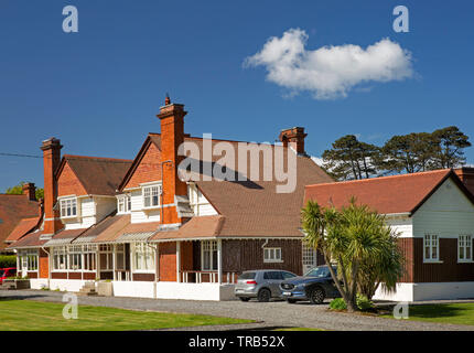 Ireland, Co Louth, Greenore, elegant colonial style DNGR Railway management house with verandah in garden Stock Photo