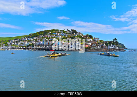The Dartmouth Lower Ferries pass each other on the tidal river Dart towards Kingswear.They are pontoon ferries that are pushed/pulled by a tug boat . Stock Photo