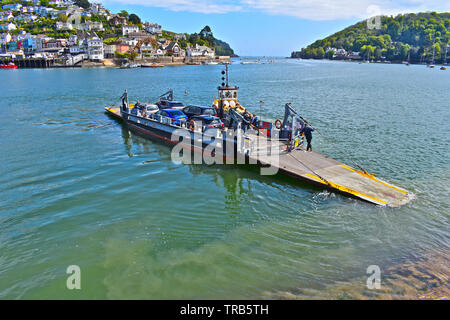 The Dartmouth Lower Ferry leaves Dartmouth,crossing the tidal river Dart towards Kingswear.This is a pontoon ferry that is pushed/pulled by a tug boat Stock Photo
