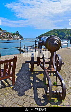 A view towards the river Dart estuary from Dartmouth quayside. The lower ferry is departing for Kingswear. Old canon in foreground pointing out to sea Stock Photo