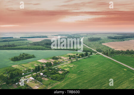 Vasilyovka, Dobrush District, Gomel Region, Belarus. Aerial View Of Wooden Houses At Spring Sunset Dawn Sunrise Time. Beautiful Rural Landscape In Bir Stock Photo