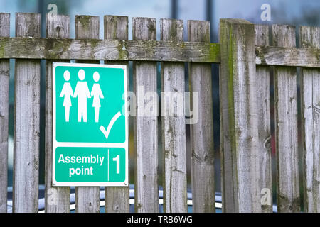 Fire assembly point sign at office work place Stock Photo