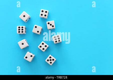 Rolling Dices over blue background. Casino gambling concept Stock Photo