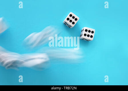 Rolling Dices over blue background. Casino gambling concept Stock Photo
