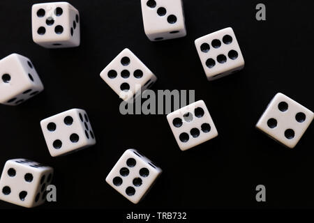 Rolling Dices over black background. Casino gambling concept Stock Photo