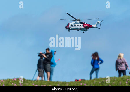 A Sikorsky S-92A HM Coastguard SAR Helicopter G-MCCZ operated by Bristol Helicopters flying overhead in England, UK. Stock Photo