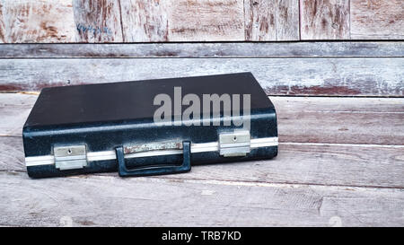 Black business leather briefcase, handbag with key lock at office , company wooden background Stock Photo