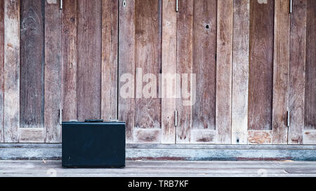 Black business leather briefcase, handbag with key lock at office , company wooden background Stock Photo