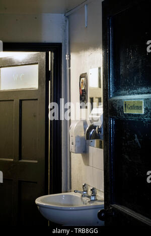 gents toilet in old pub Stock Photo