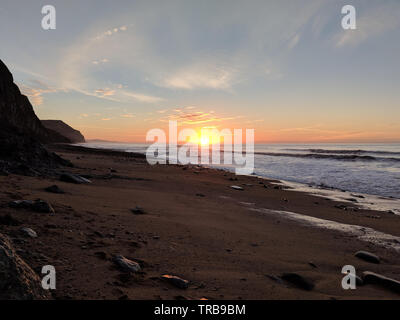 Charmouth beach winter sunrise looking towards golden cap Stock Photo