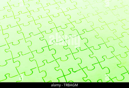Assembled puzzle on a bright green background. Stock Photo