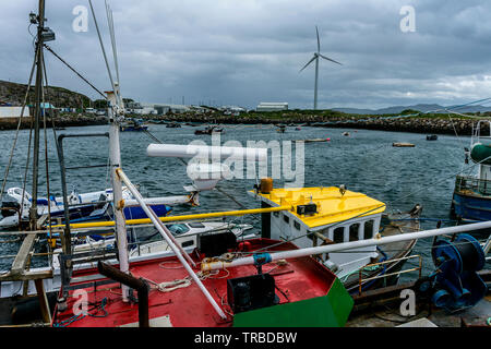 Burtonport, County Donegal, Ireland. 2nd June 2019. Brightly painted fishing boats moored in the harbour give a splash of colour on an otherwise overcast, wet and windy day on the north-west coast. Richard Wayman/Alamy Live News Stock Photo