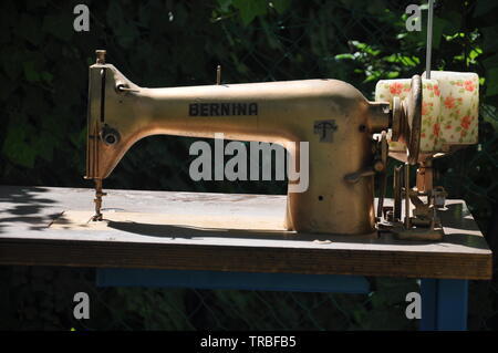 Old gold-colored sewing machine Stock Photo