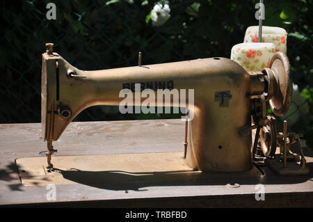 Old gold-colored sewing machine Stock Photo